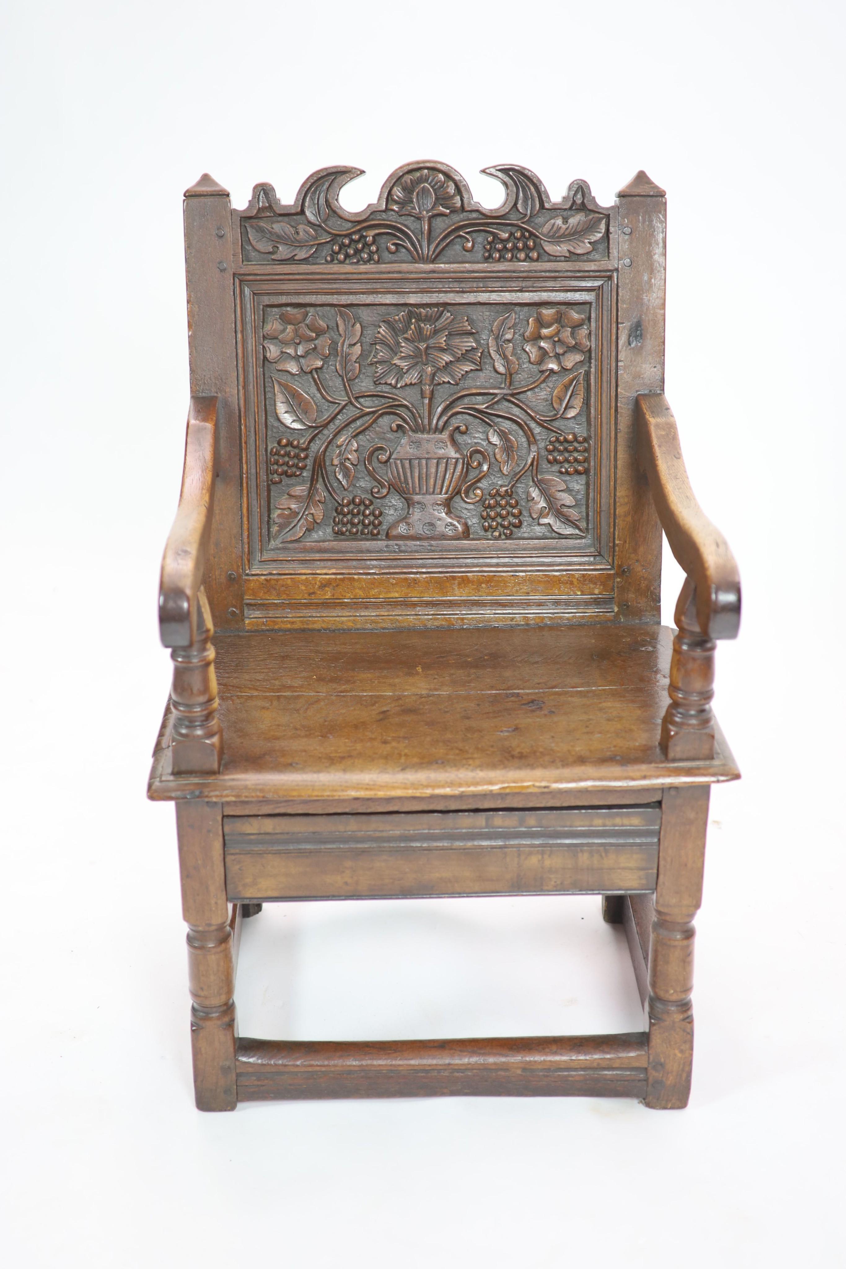 A South Lancashire/North Cheshire Charles II carved and panelled oak open armchair H 93cm. W 60cm. D 53cm.
